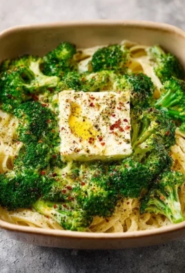 Baked feta pasta with broccoli in a white bowl