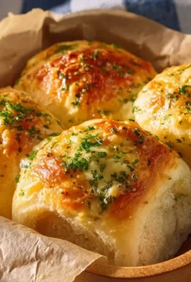 Delicious buttery cheese garlic rolls garnished with herbs