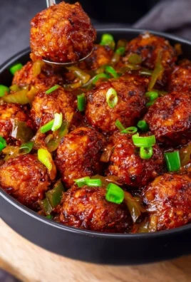 Delicious Cabbage Manchurian served in a bowl, garnished with green onions.