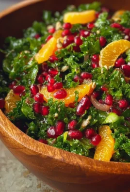 A vibrant Citrus Pomegranate Kale Salad with fresh ingredients and colorful toppings.