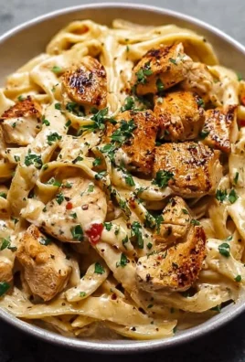Creamy Cajun Chicken Pasta garnished with herbs and served in a bowl