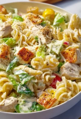 Creamy chicken pasta salad with vegetables in a bowl