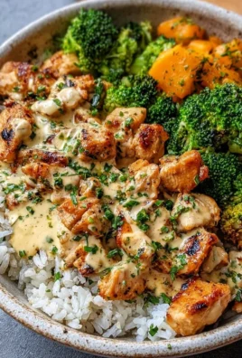 Delicious creamy garlic chicken rice bowl with fresh herbs and vegetables