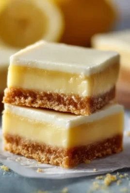 Delicious creamy lemon squares served on a decorative plate
