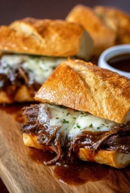 Crockpot French dip sandwiches served with au jus for dipping