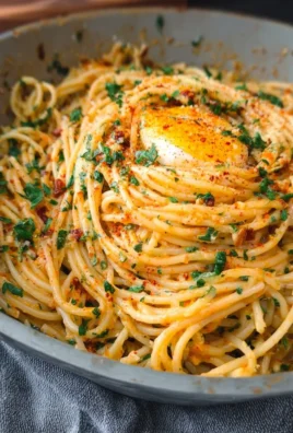 Delicious garlic butter pasta served in a bowl with herbs and grated cheese.