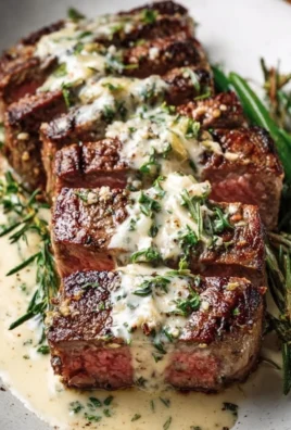 Delicious garlic butter steak topped with creamy Parmesan sauce
