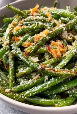 Plate of Garlic Parmesan Roasted Green Beans garnished with Parmesan cheese