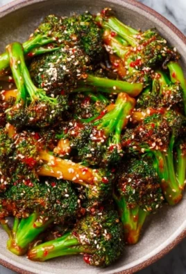 Delicious Gochujang Broccoli served on a plate with garnish.