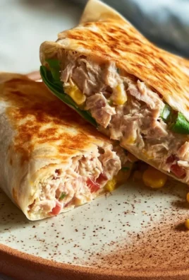 Healthy tuna melt wrap with fresh ingredients and melted cheese