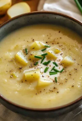 Bowl of Ina Garten's roasted potato leek soup with fresh herbs on top