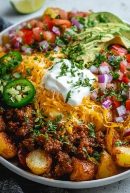 Delicious loaded potato taco bowl with toppings and seasonings
