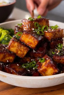Deliciously cooked Maple Glazed Tofu served on a plate with fresh vegetables
