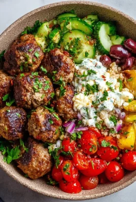 Mediterranean meatball bowl with fresh ingredients and herbs
