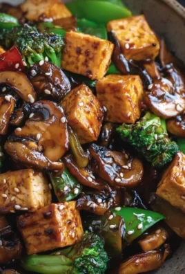 Mushroom Tofu Stir-Fry with colorful vegetables and herbs in a vibrant pan
