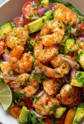 Delicious shrimp salad in a bowl with fresh vegetables and dressing.