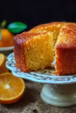 Sicilian Whole Orange Cake topped with orange slices on a white plate