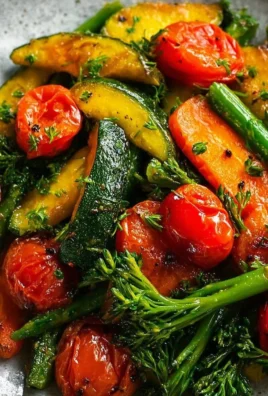 Colorful assorted sautéed vegetables on a plate, showcasing healthy cooking.