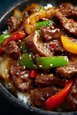Chinese pepper steak with onions served sizzling in a pan
