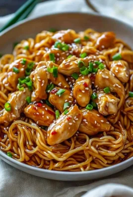 Delicious sticky garlic chicken noodles served in a bowl.
