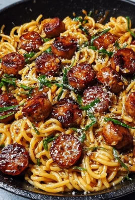 Sticky honey garlic sausage pasta skillet on a wooden table