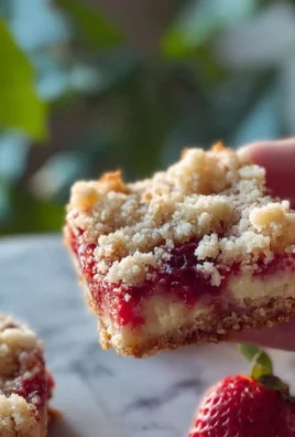 Strawberry cheesecake crumb bars topped with fresh strawberries and crumbly crust.