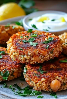 Plate of lemon chickpea patties served with yogurt sauce garnished with herbs