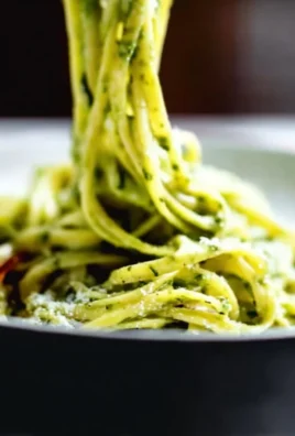Creamy avocado pasta sauce served with fresh herbs and cherry tomatoes