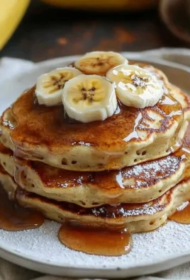Delicious baked banana foster pancakes topped with caramelized bananas and syrup
