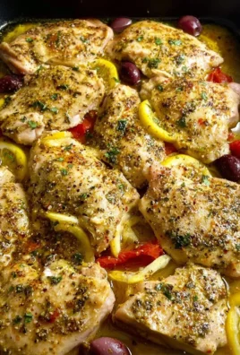 Baked Greek Lemon Chicken garnished with herbs and lemon slices, ready to serve
