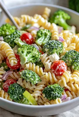A bowl of the best broccoli pasta salad with colorful vegetables and dressing