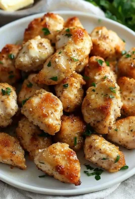 Delicious Butter Garlic Chicken Bites served on a plate with herbs.