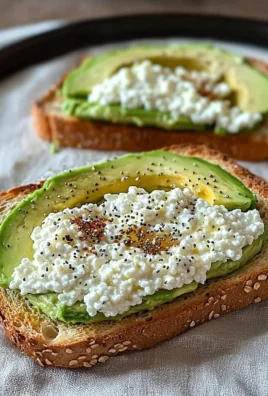 Close-up of cottage cheese avocado toast topped with herbs and spices