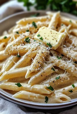 Creamy garlic penne pasta dish served in a bowl with herbs garnish