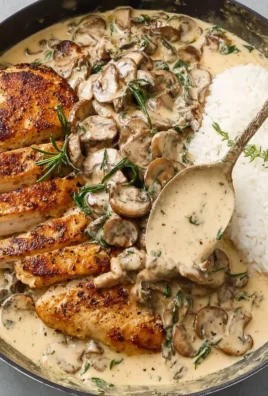Creamy mushroom chicken served on a plate with herbs and spices