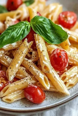 Bowl of creamy tomato ricotta pasta garnished with basil and parmesan cheese