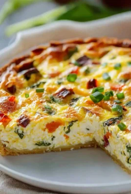 Crustless ricotta quiche served on a plate, showcasing fluffy texture and vibrant colors.