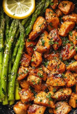 Garlic Butter Chicken Bites served with Lemon Asparagus on a plate