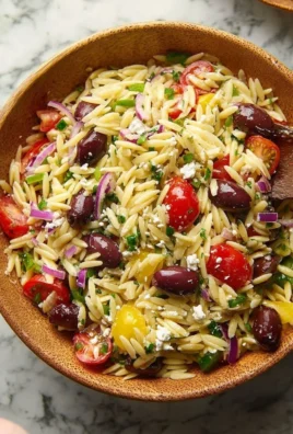 Colorful Greek Orzo Salad with vegetables and feta cheese