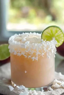 Delicious Guava Coconut Margarita cocktail in a glass with tropical garnishes