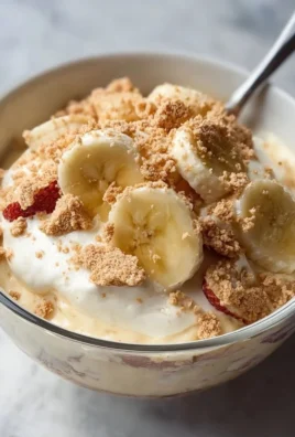 Healthy high protein banana pudding bowl topped with banana slices and nuts