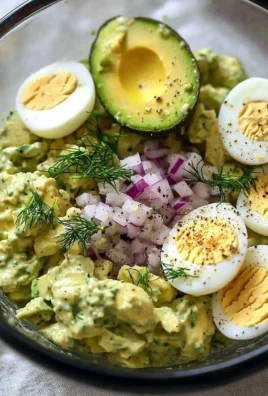 Herby Avocado Egg Salad served in a bowl with garnishes