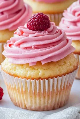 Lemon cupcakes with raspberry buttercream frosting on a decorative plate