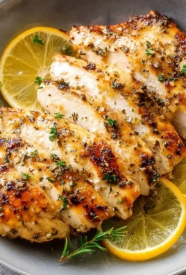 Delicious Lemon Garlic Chicken served with herbs and vegetables