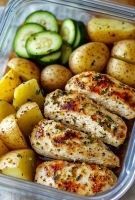 Lemon garlic chicken meal prep dishes arranged in meal containers