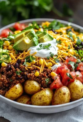 Loaded Potato Taco Bowl filled with potatoes, cheese, and toppings.