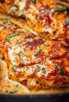 Creamy Marry Me Chicken served with herbs and pasta on a plate.
