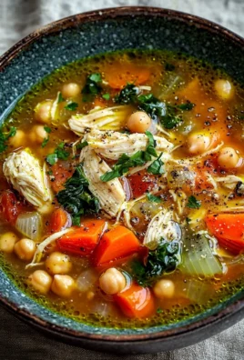 Bowl of Mediterranean Chicken Soup with fresh herbs and vegetables
