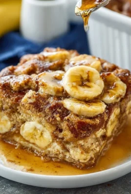 Overnight baked banana french toast casserole topped with fresh banana slices