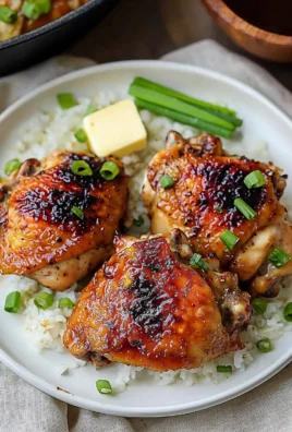 Juicy roasted miso chicken thighs garnished with green onions and sesame seeds.